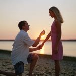 Man proposing to woman on beach